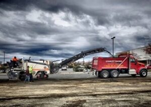 A Stanley Paving truck with heavy equipment.