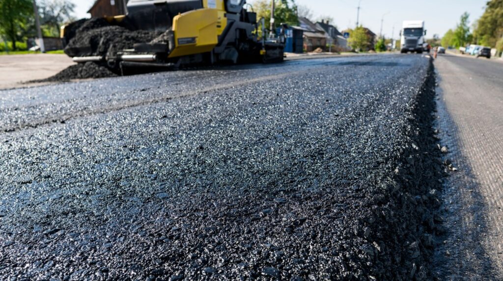 A close-up of fresh asphalt on a road.
