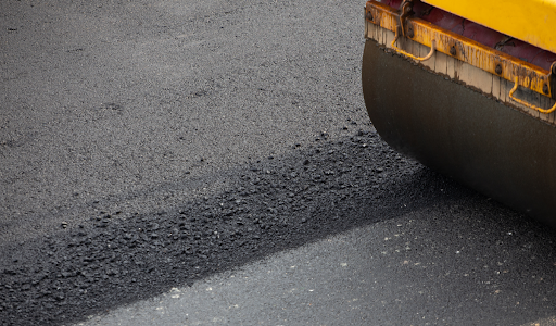 A close-up of an asphalt paving machine.