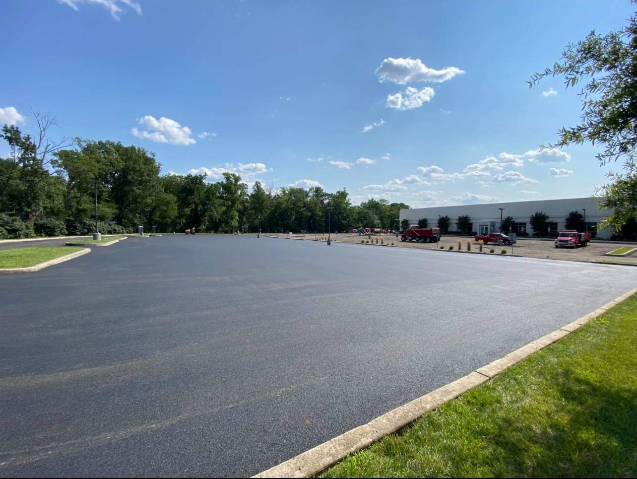 Smooth, freshly repaved asphalt parking lot surrounding a commercial office building in Princeton New Jersey by Stanley Paving.